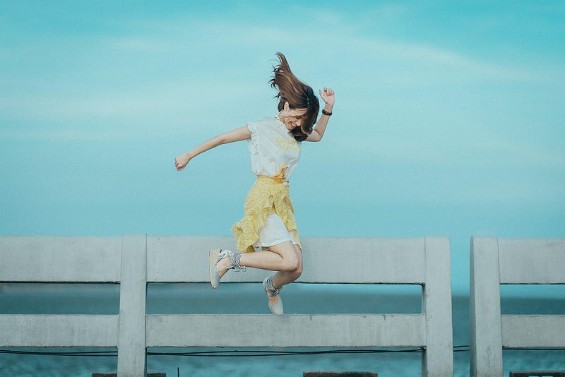 Woman joyfully learning by the water