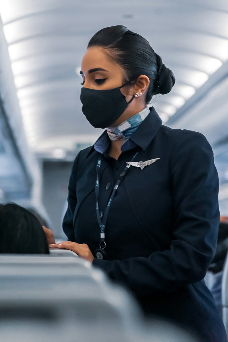 Flight attendant apologizing to a passenger