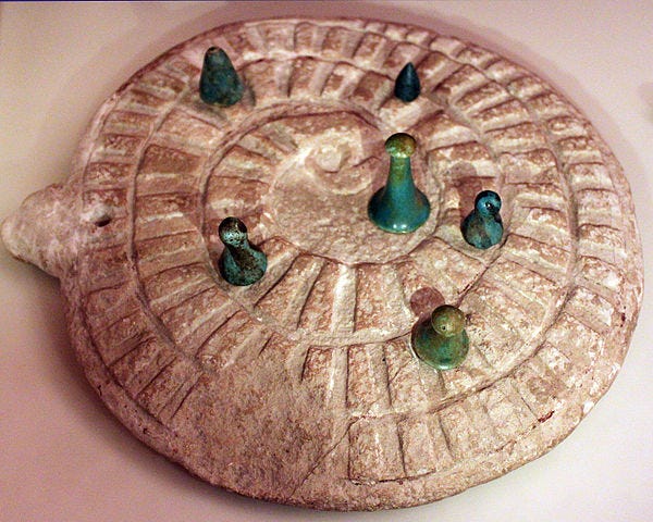 Ancient game of Mehen, reflecting the ouroboros concept.